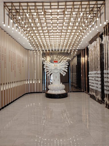 Illuminated memorial corridor with a Guanyin statue at Nirvana Melaka