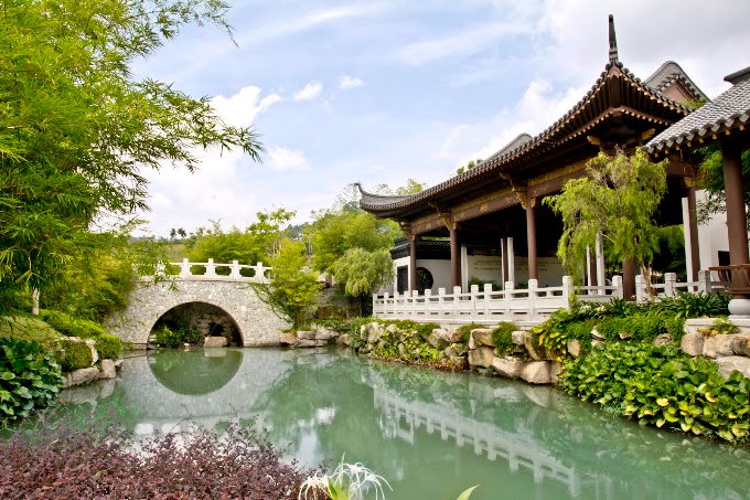 Moon bridge, pond and traditional pavilion in the Shi Wai Tao Yuan garden at Nirvana Semenyih