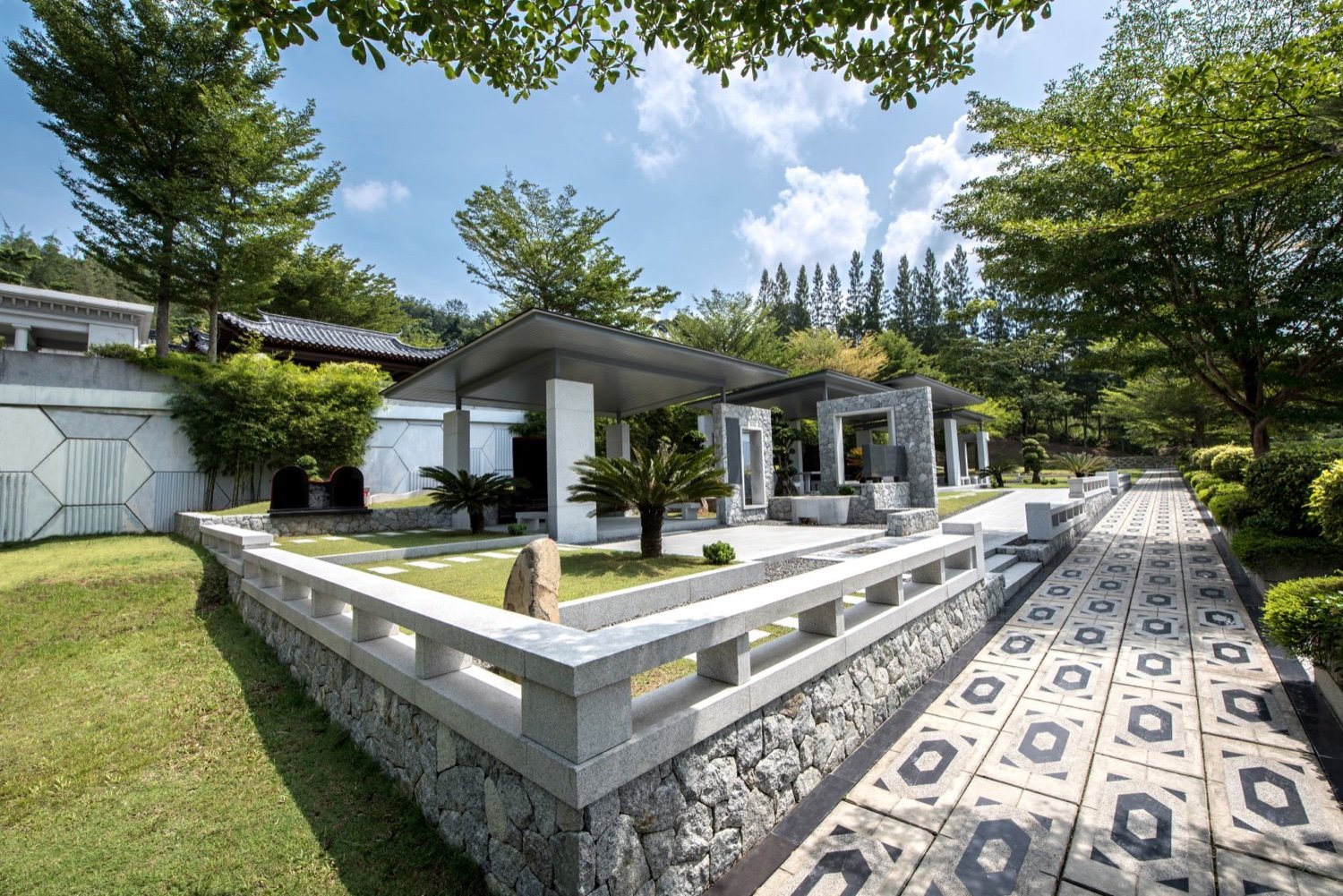Private family burial plot with landscaped stonework and covered memorial structures