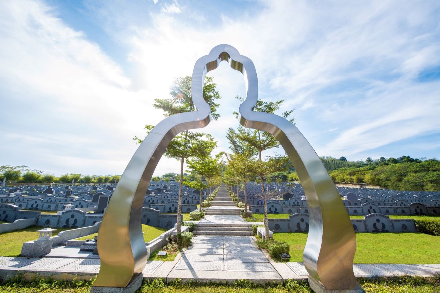 Sculptural gateway within a landscaped memorial park