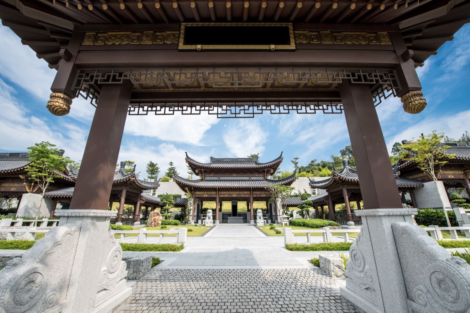 Traditional pavilion and ceremonial gateway within a memorial garden