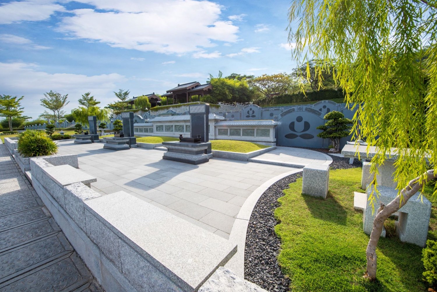 Individual and paired burial plots within a green landscaped garden