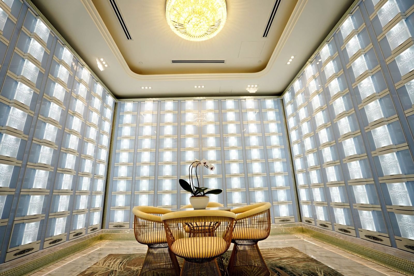 Bright Christian columbarium hall with cross-inspired niche panels and visitor seating