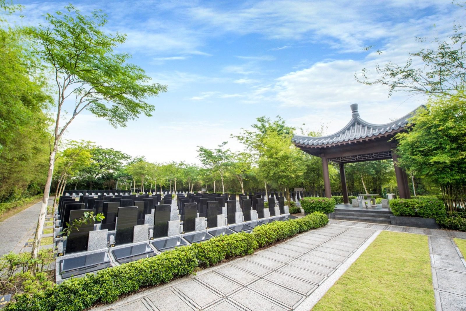 Landscaped urn garden with individual memorial plots and a traditional pavilion