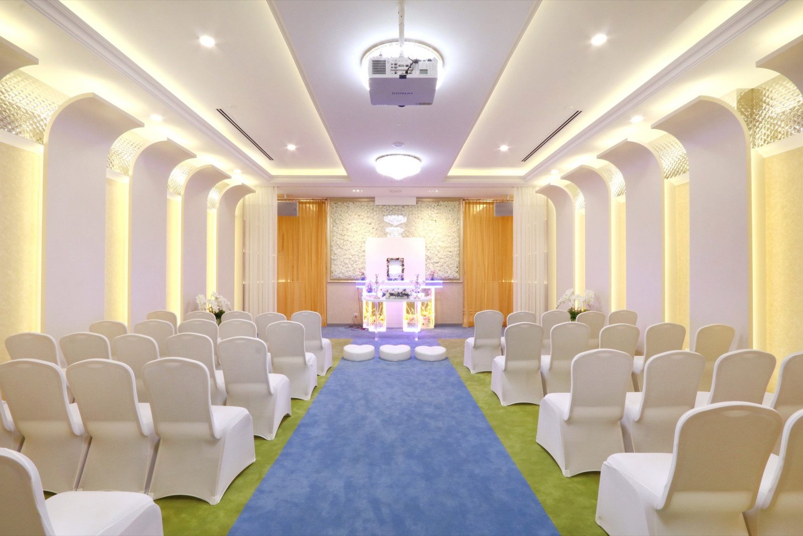 Bright memorial parlour arranged with seating and a central ceremony space