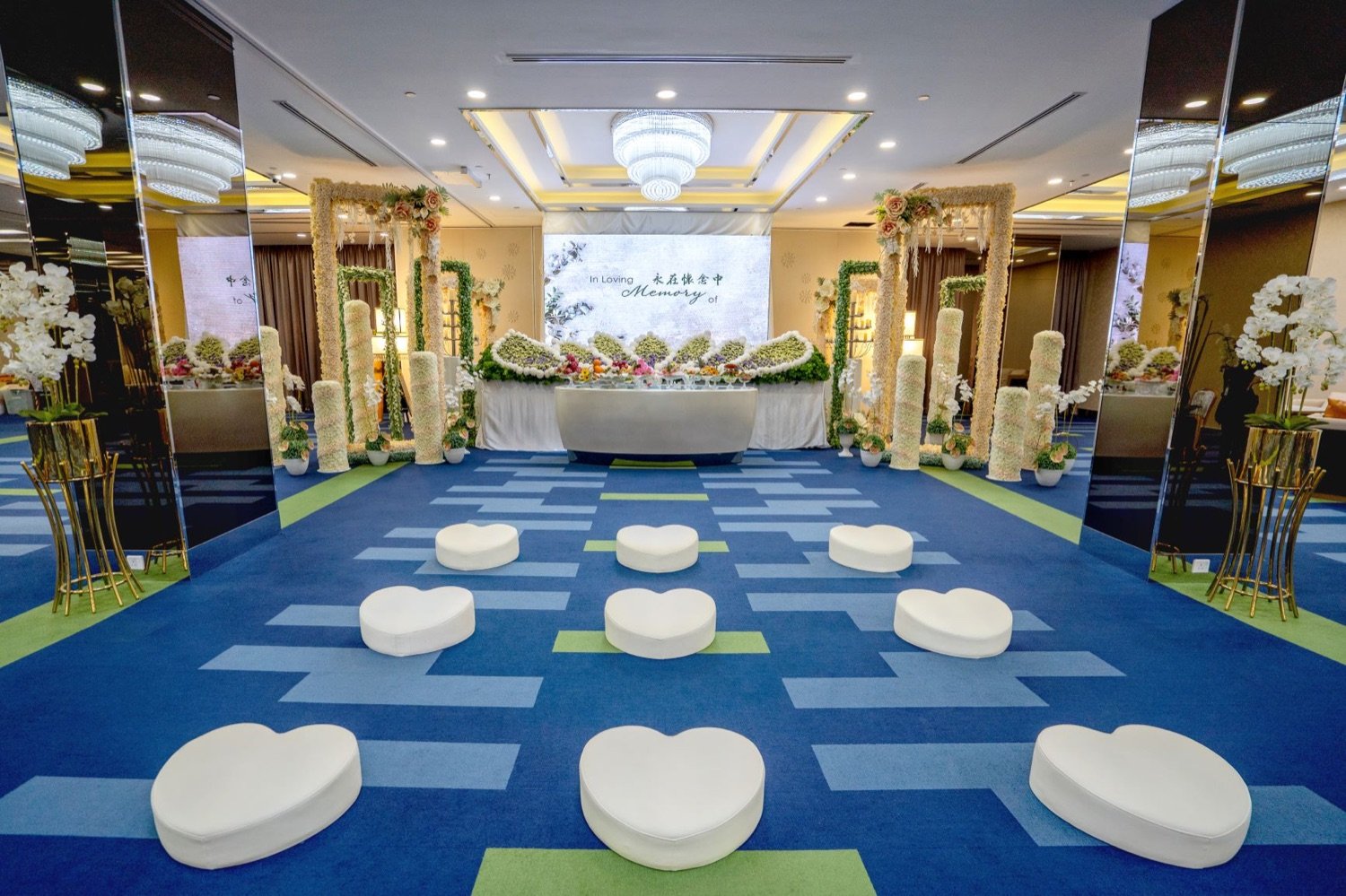 Memorial ceremony setting with floral arrangements and a remembrance display